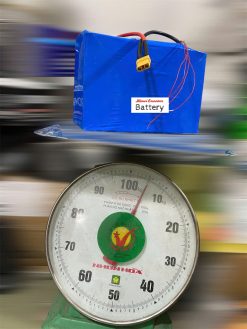 A Lithium ion battery with heatshrink and jack xt90 on a scale.